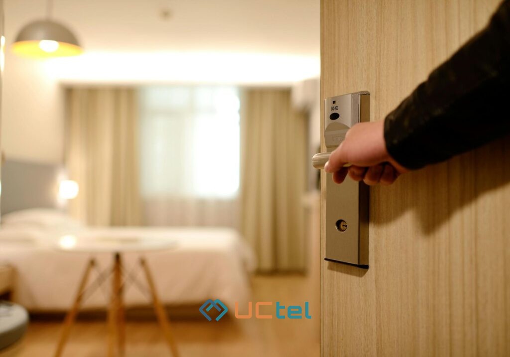 Modern hotel room with large bed, desk, and ambient lighting