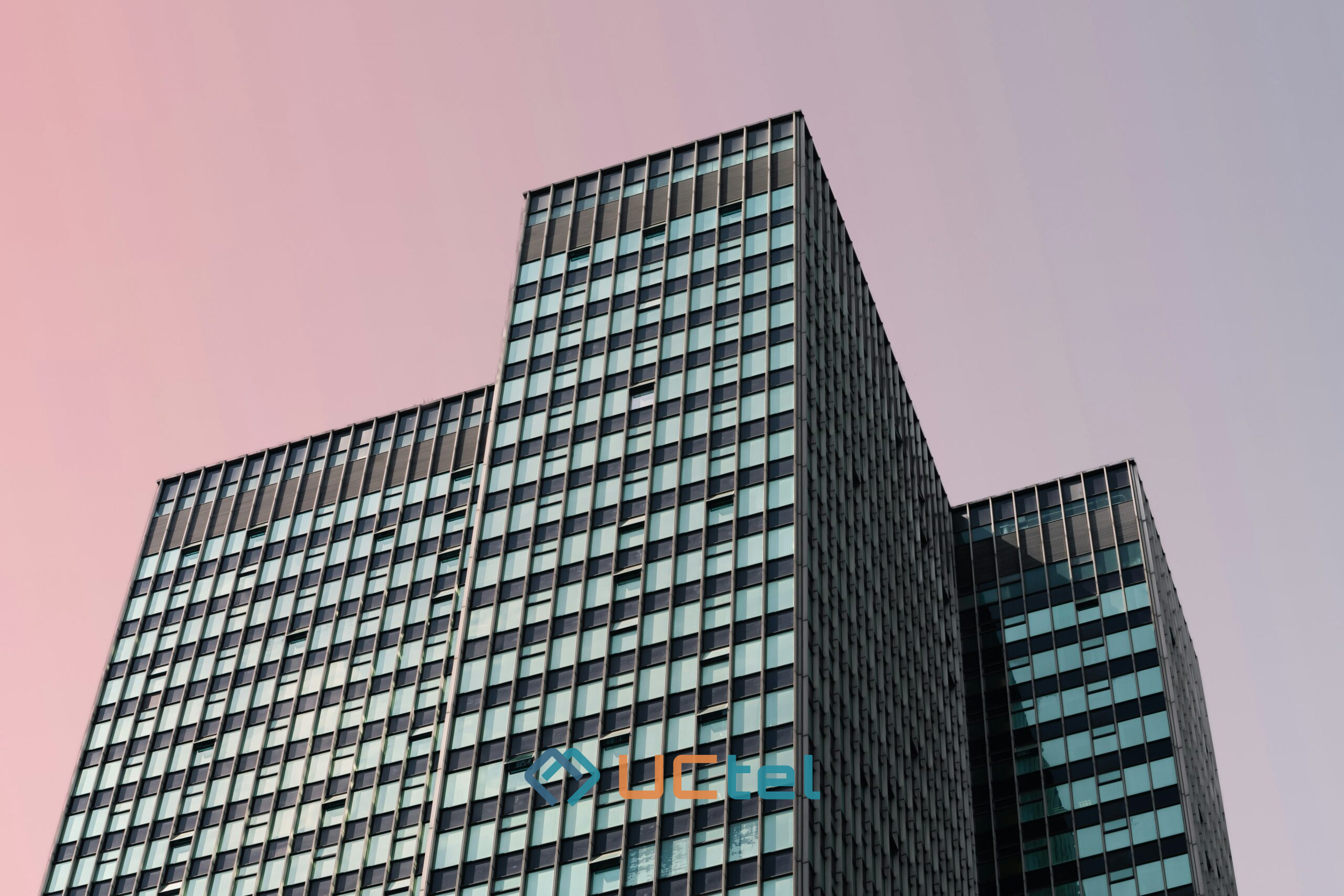 Modern office building exterior representing in-building booster deployments compliant with Ofcom regulations