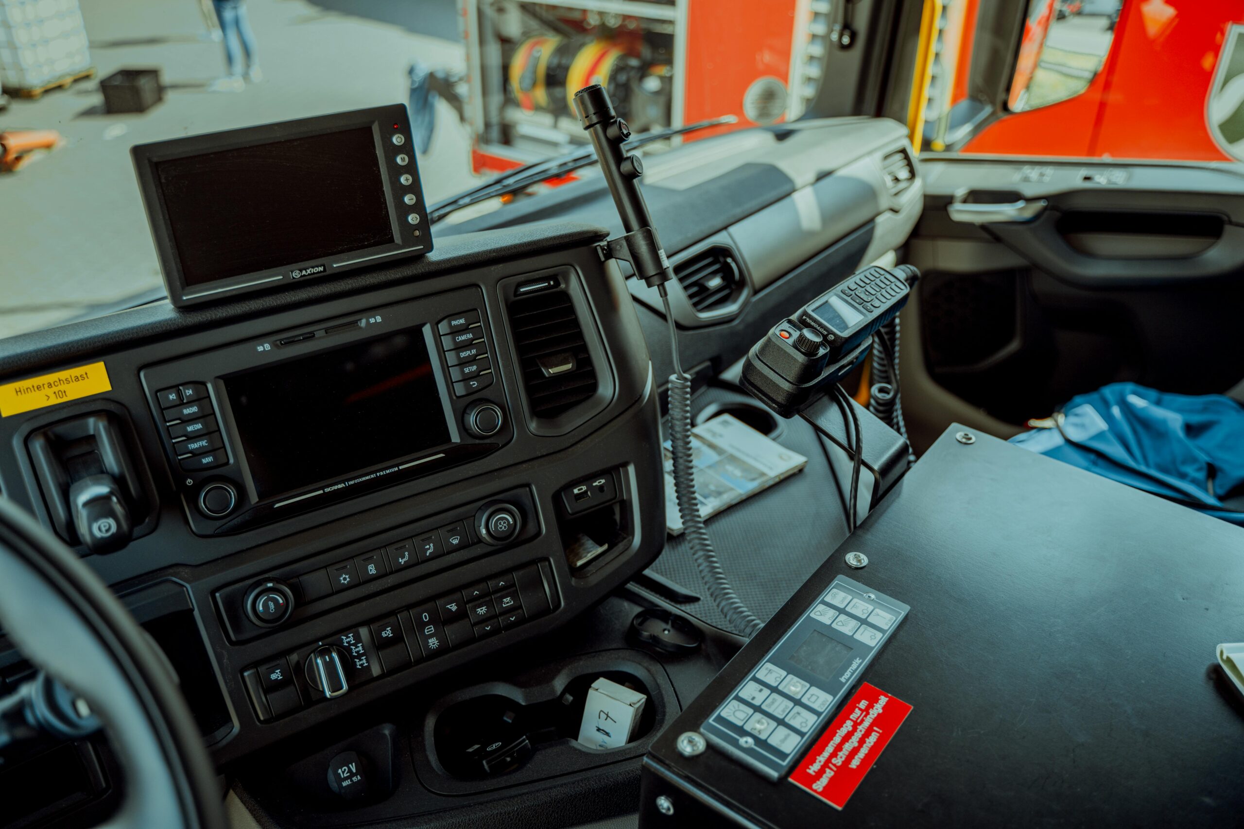 Emergency response vehicle dashboard with communication equipment, illustrating secure mobile coverage systems for first responders
