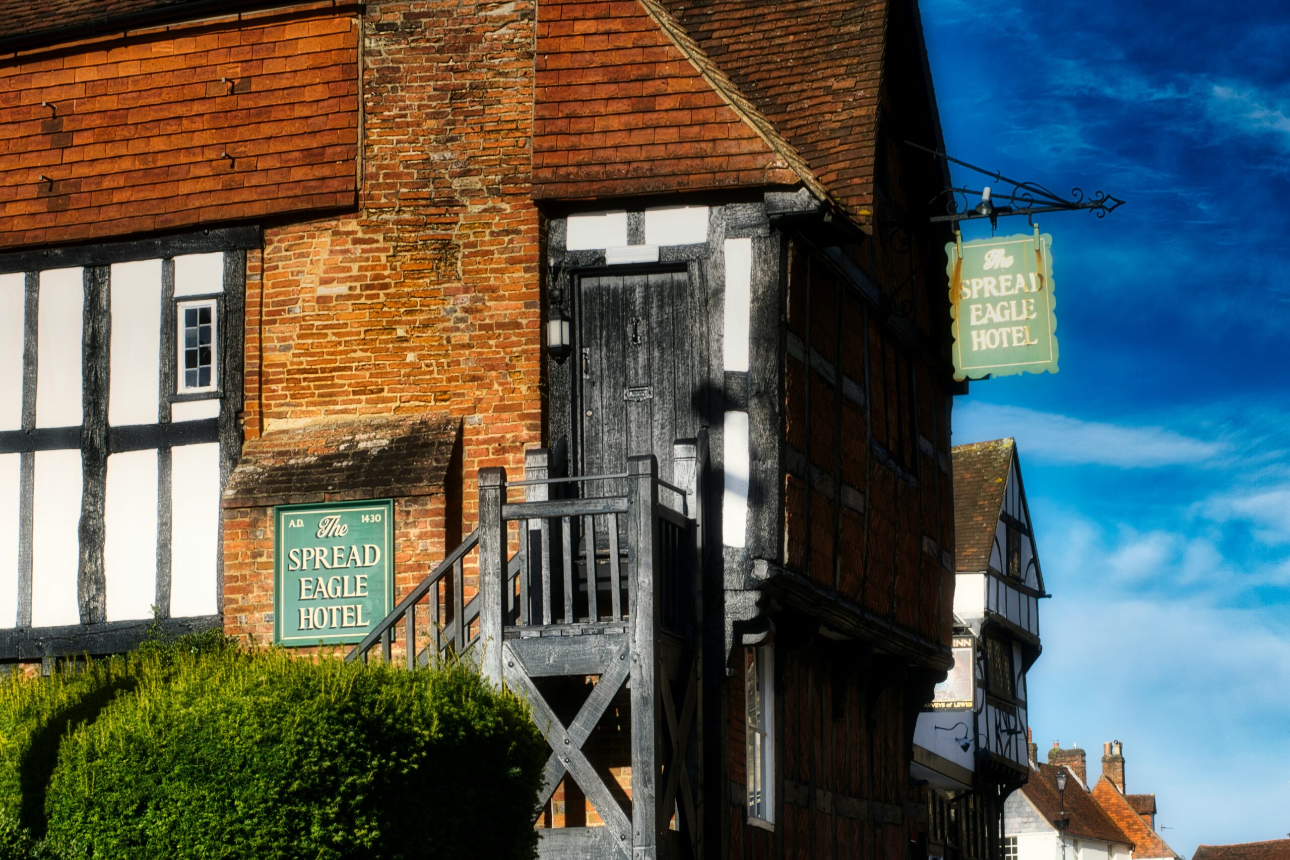 Historic hotel exterior with timber-framed façade and sign, representing hotel Wi-Fi and mobile booster integration