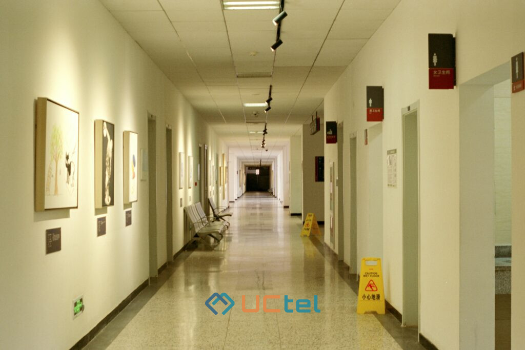 Hospital corridor with lights and signage, illustrating the need for reliable mobile coverage in medical facilities