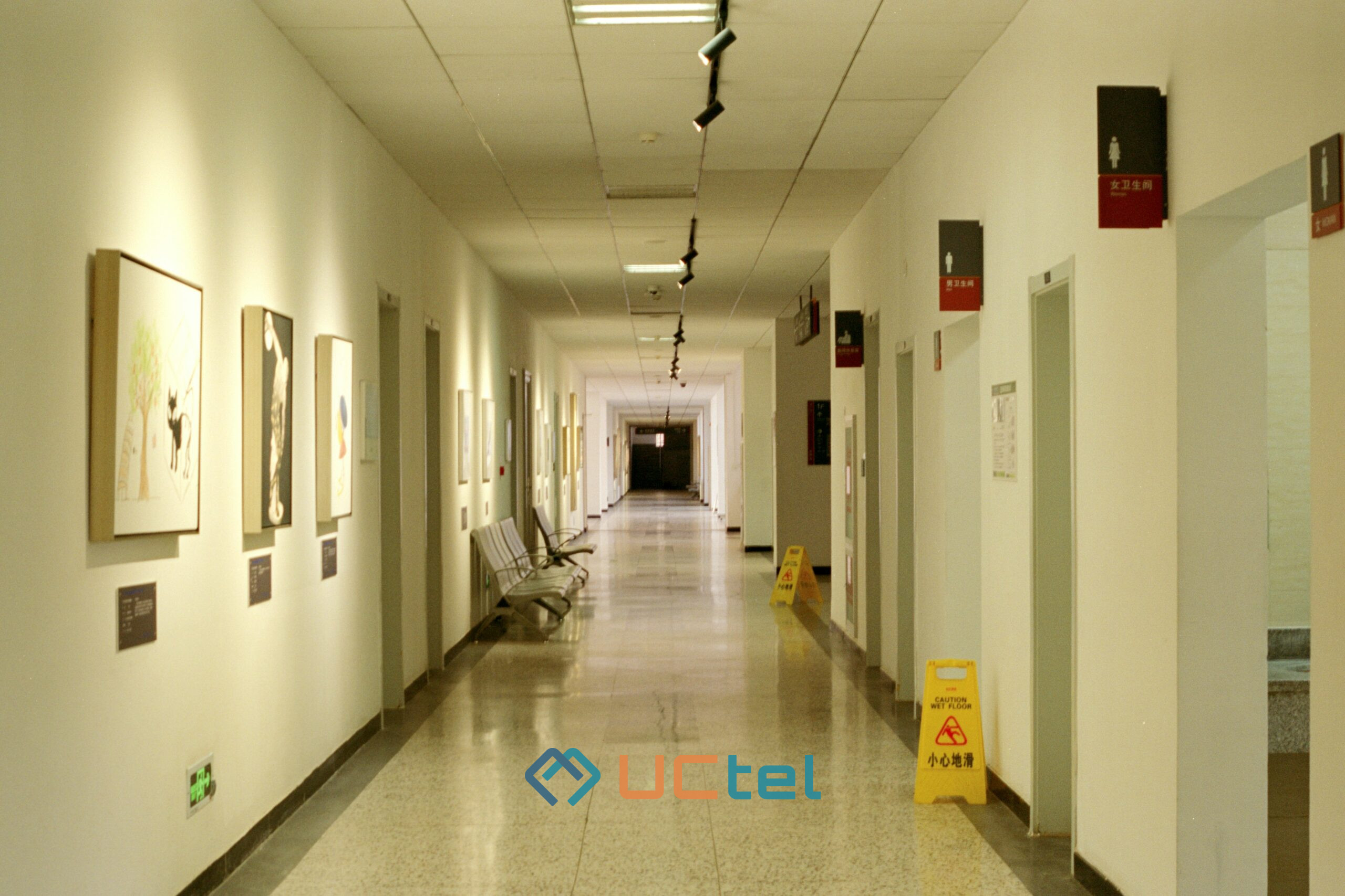 Hospital corridor with lights and signage, illustrating the need for reliable mobile coverage in medical facilities